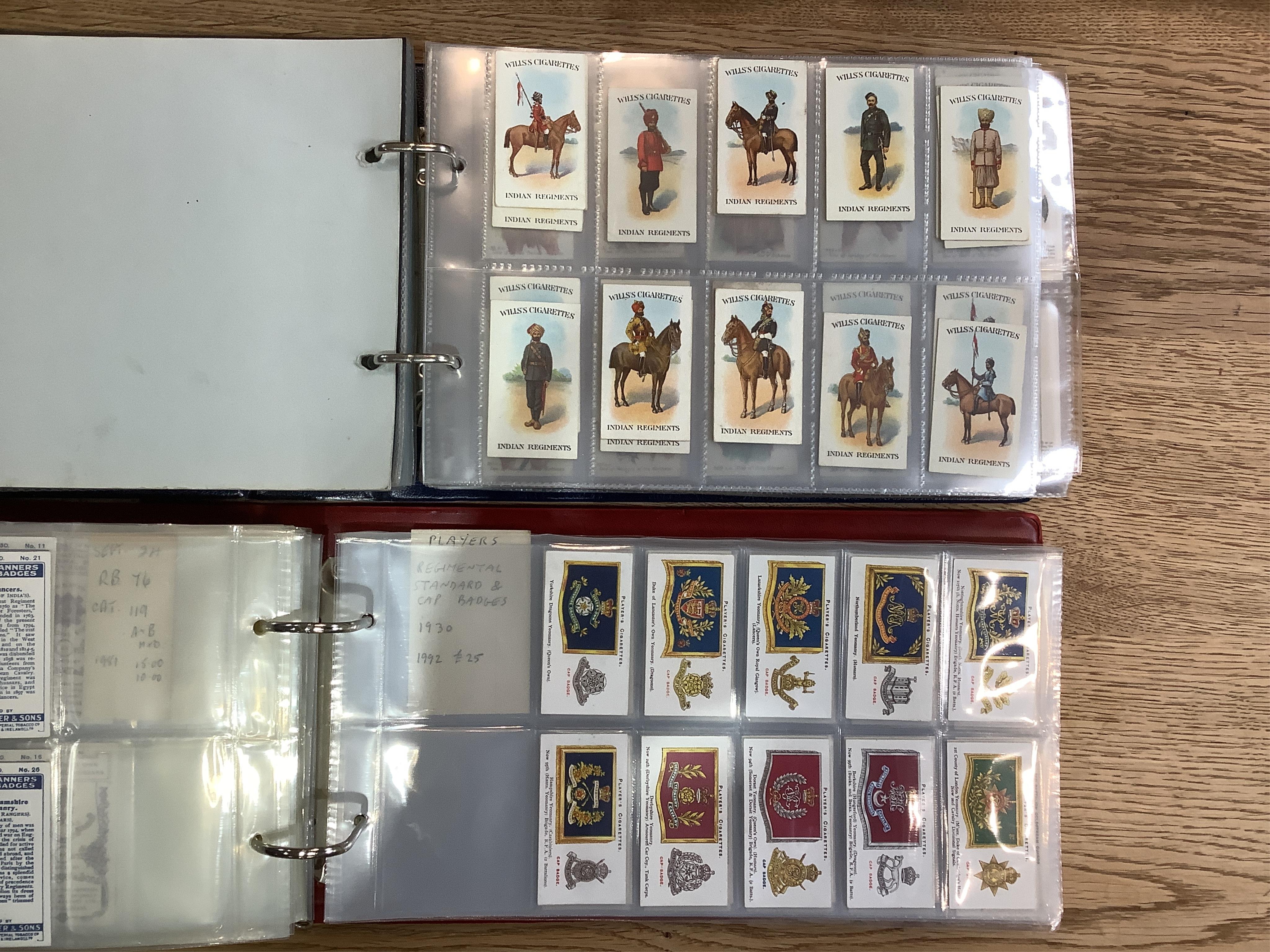 Four albums of assorted cigarette cards; military badges, heroes, soldiers and war, and some loose silks.